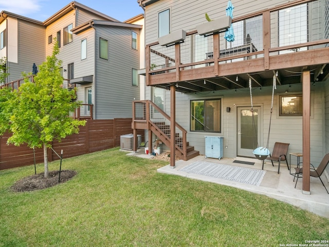 rear view of property with a lawn, a patio, and a deck