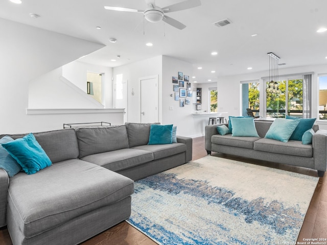 living room with wood-type flooring and ceiling fan