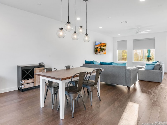 dining area with ceiling fan and dark hardwood / wood-style floors