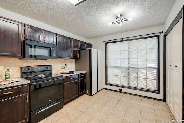 kitchen with tasteful backsplash, dark brown cabinets, a textured ceiling, light tile patterned floors, and black appliances