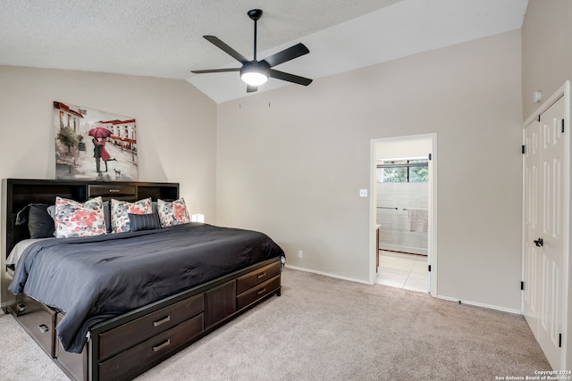 carpeted bedroom with lofted ceiling, ceiling fan, ensuite bathroom, and a textured ceiling