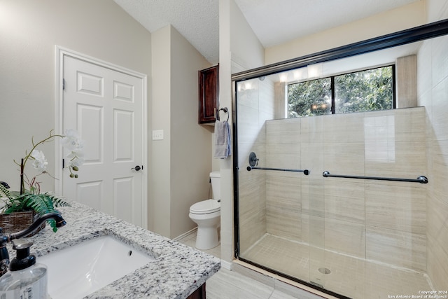 bathroom featuring toilet, an enclosed shower, tile patterned floors, vanity, and a textured ceiling