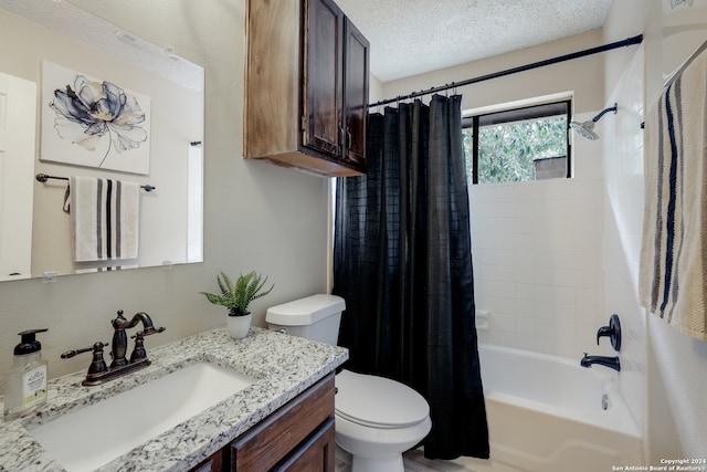 full bathroom with vanity, a textured ceiling, toilet, and shower / bath combo with shower curtain