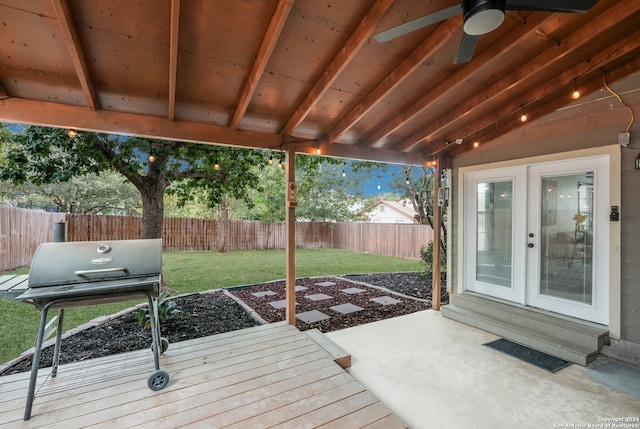 wooden terrace featuring a patio area, a lawn, french doors, ceiling fan, and area for grilling