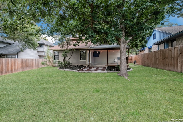 back of property featuring a lawn and a patio