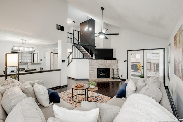 living room with a fireplace, french doors, hardwood / wood-style floors, ceiling fan, and high vaulted ceiling