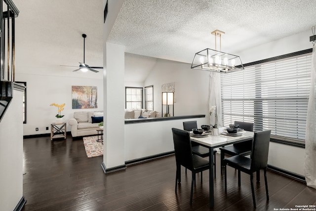 dining area featuring a textured ceiling, vaulted ceiling, dark hardwood / wood-style floors, and ceiling fan with notable chandelier