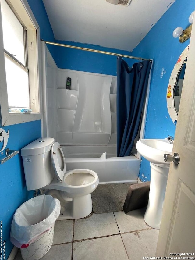 bathroom featuring toilet, tile patterned floors, and shower / bath combination with curtain