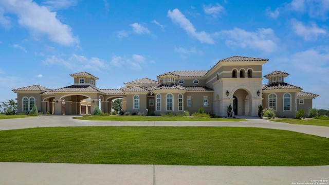 mediterranean / spanish house with a front yard