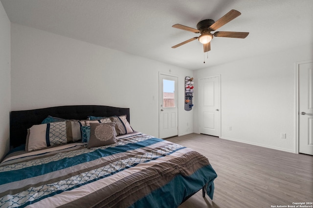 bedroom with ceiling fan and light wood-type flooring