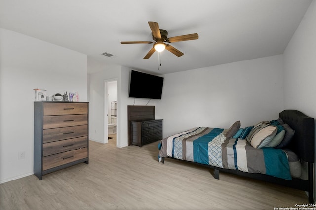 bedroom with ceiling fan, connected bathroom, and light hardwood / wood-style floors