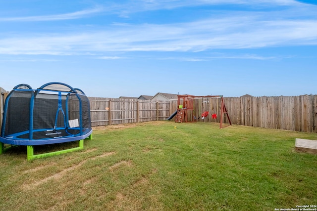 view of yard featuring a playground and a trampoline