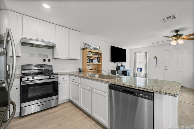 kitchen featuring stainless steel appliances, kitchen peninsula, ceiling fan, light wood-type flooring, and white cabinets