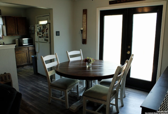 dining space featuring french doors, dark hardwood / wood-style flooring, and plenty of natural light