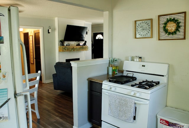 kitchen featuring ornamental molding, a textured ceiling, white appliances, and dark hardwood / wood-style flooring