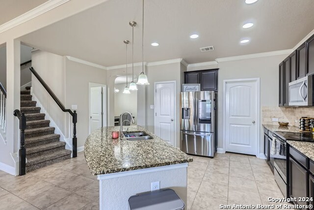 kitchen featuring ornamental molding, tasteful backsplash, sink, hanging light fixtures, and appliances with stainless steel finishes