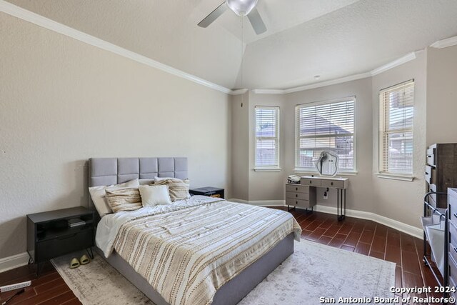 bedroom with crown molding, vaulted ceiling, and ceiling fan