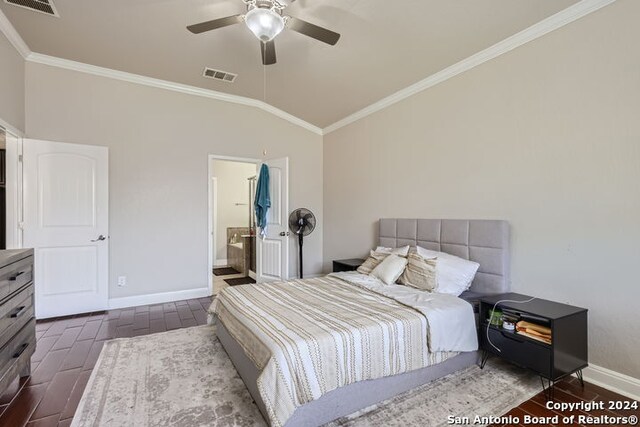 bedroom with ornamental molding, lofted ceiling, ensuite bath, and ceiling fan