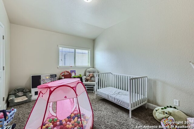 carpeted bedroom featuring lofted ceiling