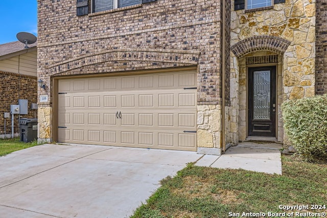 doorway to property with a garage