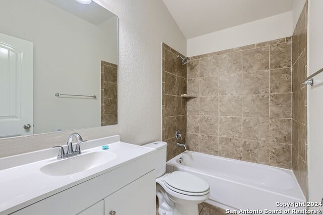 full bathroom featuring vanity, toilet, and tiled shower / bath