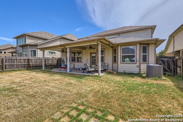 rear view of property with a lawn, ceiling fan, a patio area, and central air condition unit