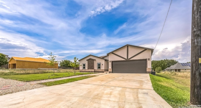 view of front of house with a garage and a front yard