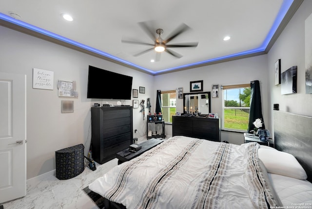 bedroom with ceiling fan, ornamental molding, and light tile patterned flooring