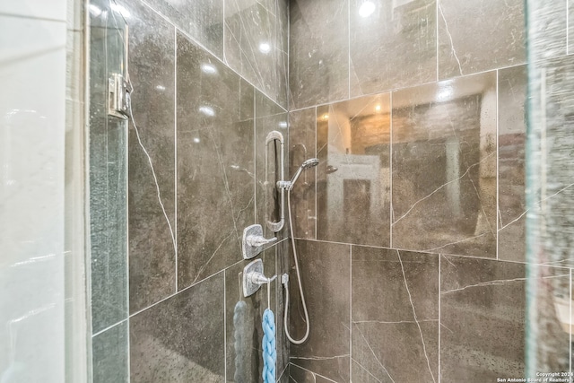 bathroom featuring a shower with door