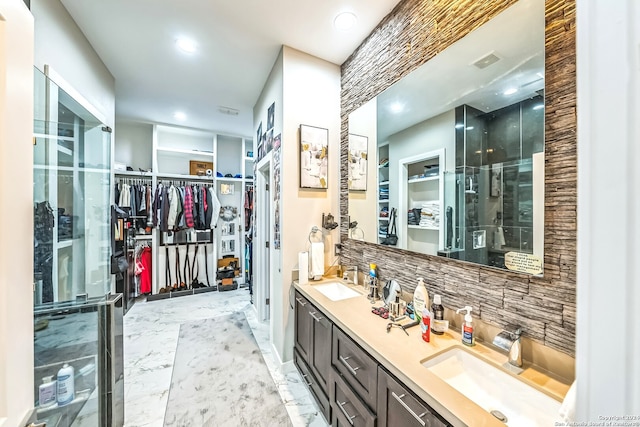 bathroom with vanity, tasteful backsplash, walk in shower, and tile patterned flooring