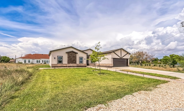 view of front of home with a garage and a front yard