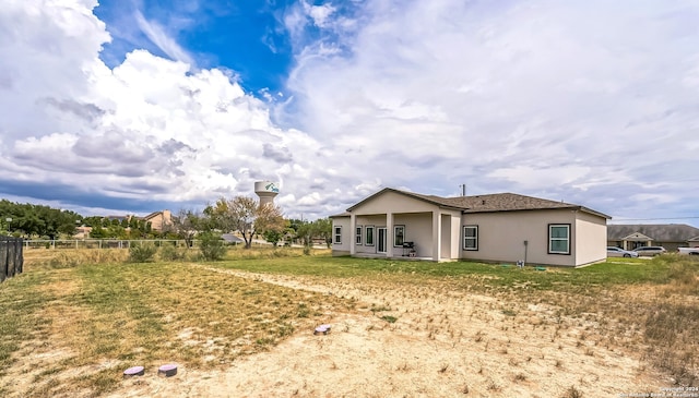 rear view of property with a lawn