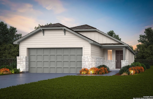 view of front of home featuring a garage, stone siding, driveway, board and batten siding, and a front yard