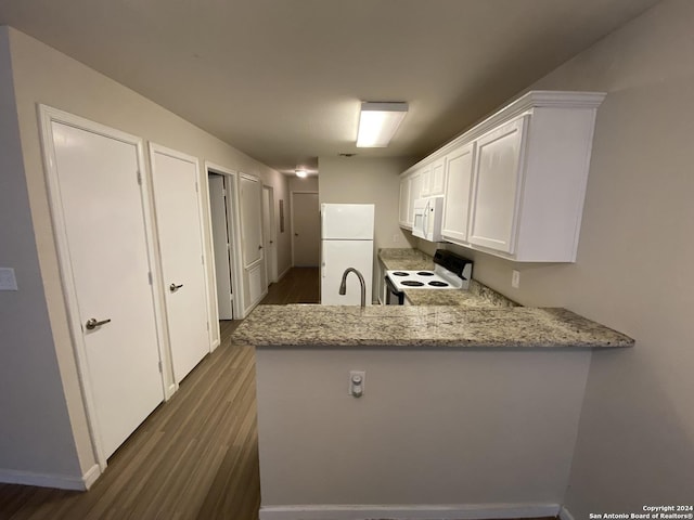 kitchen with light stone counters, white cabinets, white appliances, and dark wood-style flooring