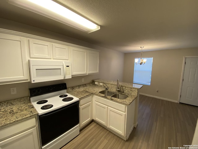 kitchen with white microwave, a peninsula, electric range, white cabinetry, and a sink