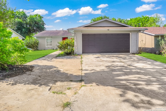 single story home featuring a garage and a front yard