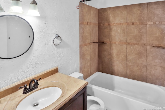 full bathroom featuring tiled shower / bath combo, vanity, and toilet