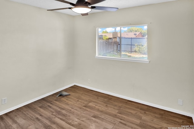 empty room featuring ceiling fan and hardwood / wood-style flooring