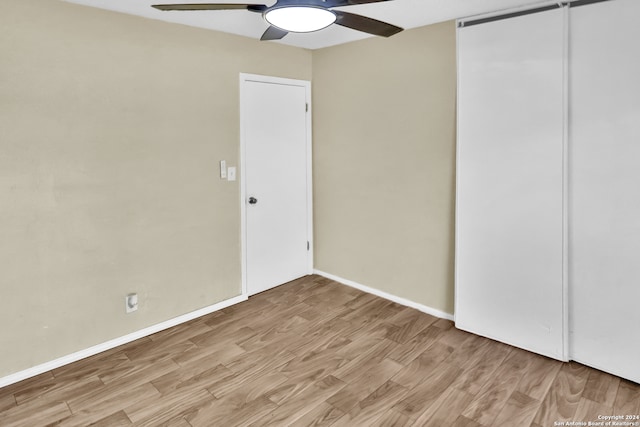 unfurnished bedroom with ceiling fan and light hardwood / wood-style floors