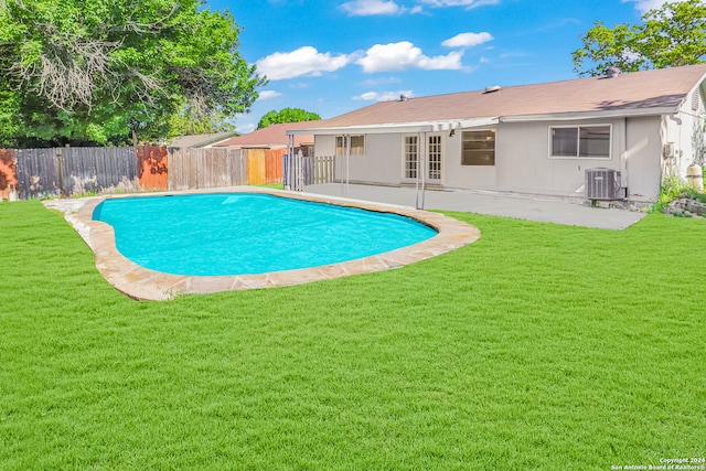 view of pool featuring a yard, a patio area, central AC, and french doors