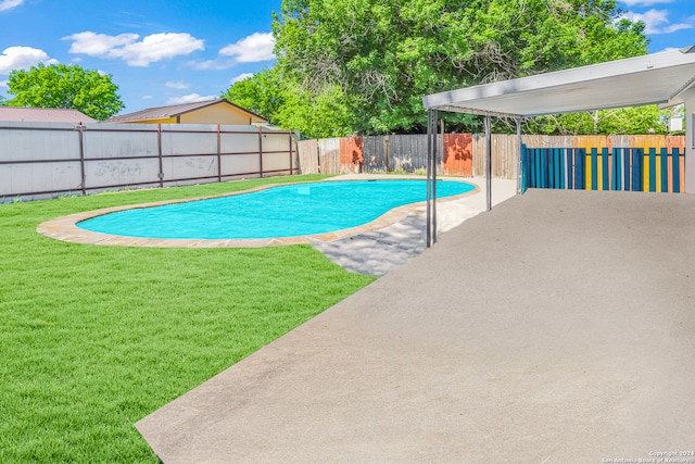 view of pool featuring a lawn and a patio area