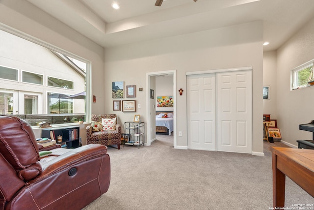 carpeted living room with ceiling fan