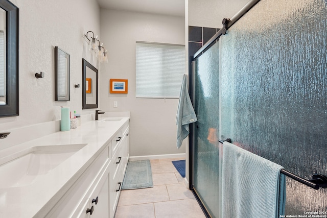 bathroom with tile patterned flooring, vanity, and walk in shower