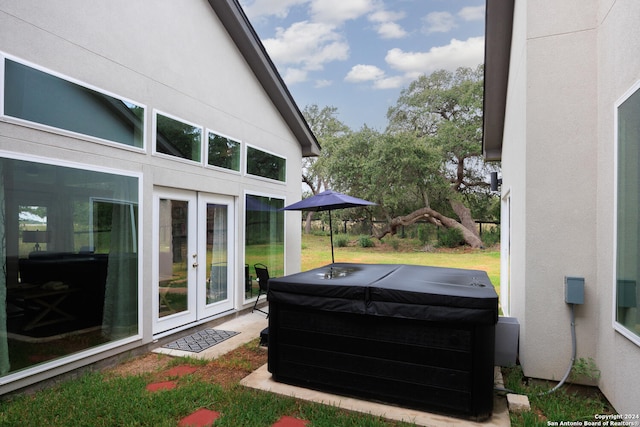 view of patio / terrace with a hot tub and french doors