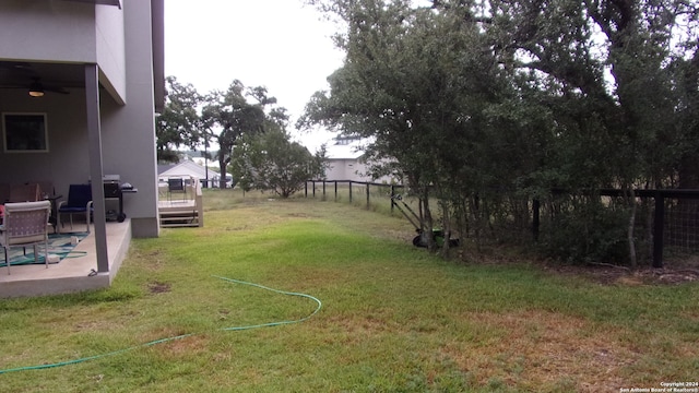 view of yard featuring a patio area and ceiling fan