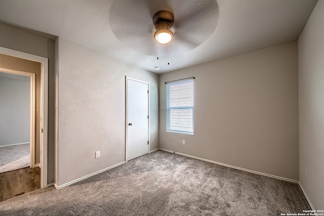 unfurnished bedroom featuring ceiling fan and carpet floors