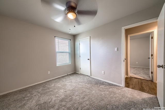 unfurnished bedroom featuring ceiling fan and carpet floors