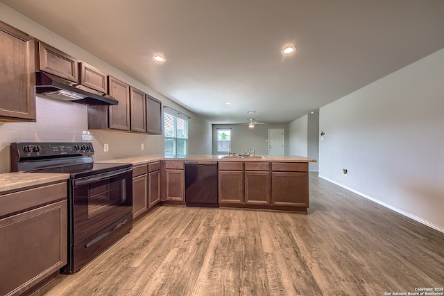 kitchen featuring dishwasher, hardwood / wood-style flooring, electric range, ceiling fan, and decorative backsplash