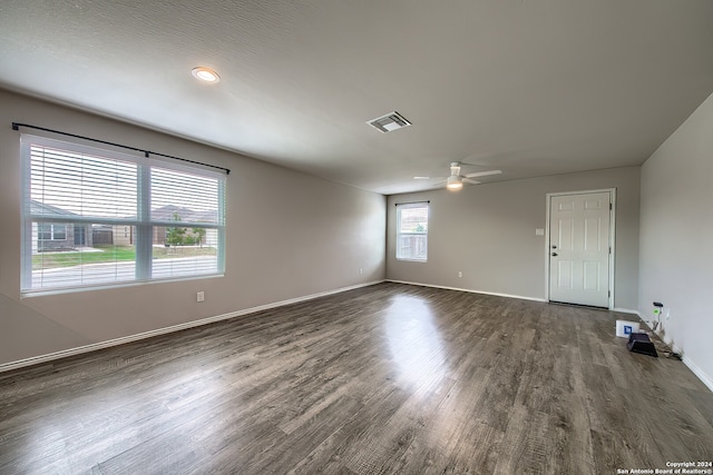 spare room with dark wood-type flooring and ceiling fan