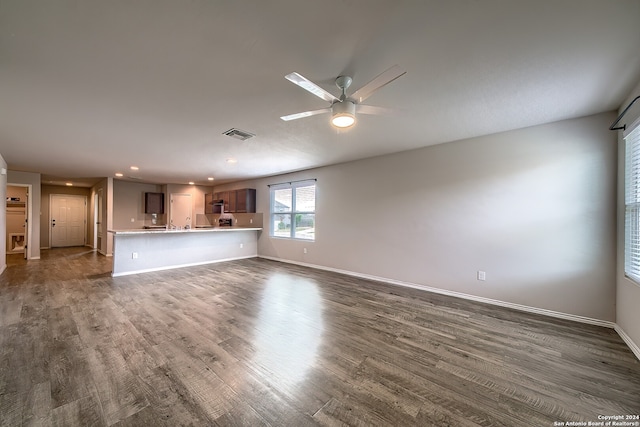 unfurnished living room with dark wood-type flooring and ceiling fan